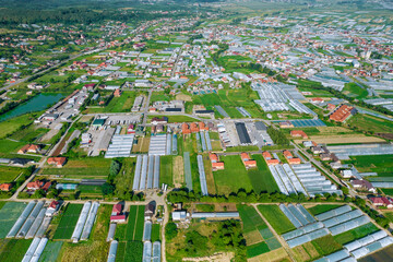 Many large greenhouses for growing vegetables. Top view. Agricultural land. Agroindustry as a business.