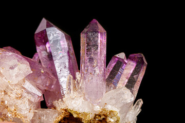 Macro of amethyst mineral stone on black background