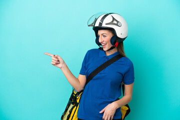 Young caucasian woman with thermal backpack isolated on white background pointing finger to the side and presenting a product