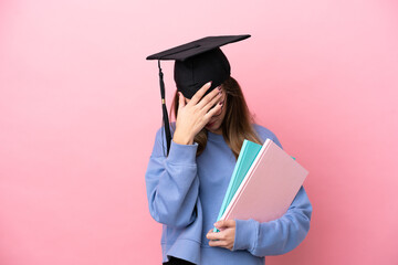 Young student woman wearing a graduate hat isolated on pink background with tired and sick expression