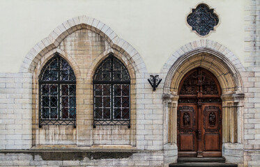 Fototapeta na wymiar Two windows and door on facade of the urban historic building front view, Tallinn, Estonia 