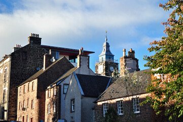 Naklejka premium Old Stone Urban Buildings with View of Distant Clock Tower 
