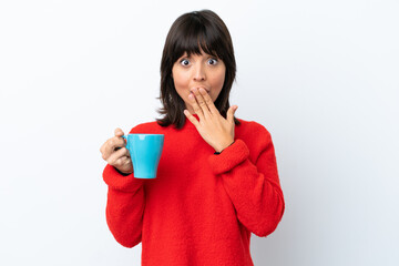 Young caucasian woman holding cup of coffee isolated on white background happy and smiling covering mouth with hand