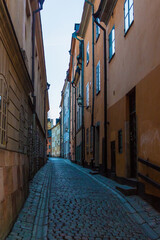 Perspective view of historical buildings on the Prastgatan Street in clear day, Stockholm, Sweden
