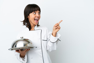 Young chef with tray isolated on white background intending to realizes the solution while lifting...