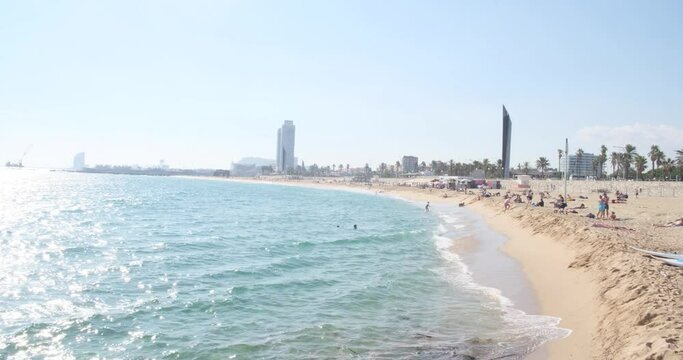 Barcelona Beach sea coast, sunny day, blue water and people relaxing. Barceloneta Beach