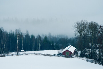 rural winter landscape with a barn