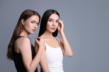 Portrait of beautiful women on grey background, space for text