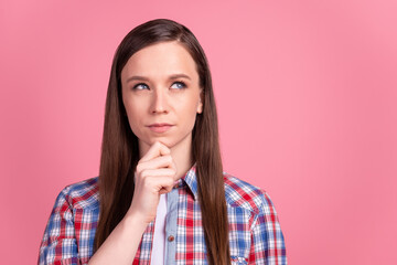 Photo of young charming girl arm touch chin minded deep think idea look empty space isolated over pink color background