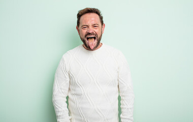 middle age handsome man with cheerful, carefree, rebellious attitude, joking and sticking tongue...