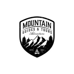 Vintage mountain themed outdoors emblem logo with bonfire and tree