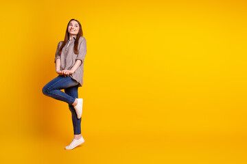 Fototapeta na wymiar Full length profile side photo of young lovely woman good mood curious look empty space isolated over yellow color background