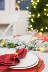 Christmas festive table setting, red towel with gold ring. Family holiday dinner or night New Year party. Vertical format. Close up.