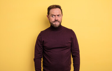 middle age handsome man looking puzzled and confused, wondering or trying to solve a problem or...
