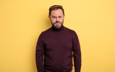 middle age handsome man feeling confused and doubtful, wondering or trying to choose or make a...