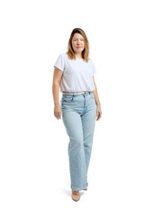 Portrait of attractive middle-aged woman wearing white t-shirt and jeans posing isolated on white...