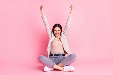 Fotobehang Full body photo of young cheerful lady rejoice victory fists hands sit lotus pose isolated over pastel color background © Tetiana