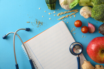 Health care guidelines with notebook and healthy food on blue