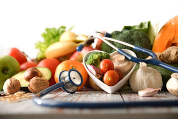 Healthy food concept with fruits and vegetables and stethoscope front