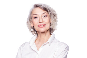 Close up portrait of pleasant grey-haired middle aged female , looking at camera with a wide smile and showing happiness, isolated on white studio background