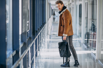 Young handsome man travelling with bag