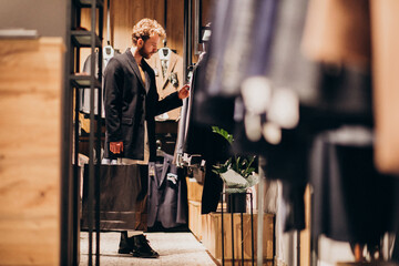 Young man shopping at menswear shop