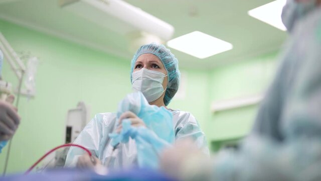 concentrated surgeon woman is performing endoscopic endonasal operating