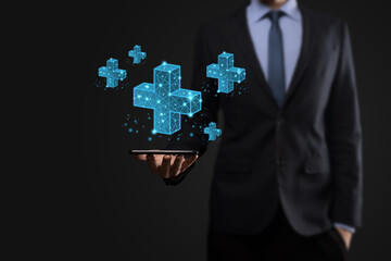 Businessman hand holding 3D plus low polygonal icon.Plus sign virtual means to offer positive thing like benefits, personal development, social network Profit,health insurance, growth concepts.