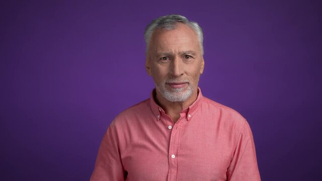 Middle aged man hide lips palm say news isolated vibrant color background