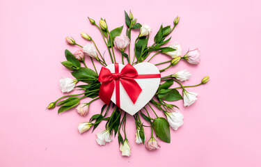 Valentine's Day. Love background. Gifts in the form of hearts on a pink background with the inscription love flower bouquet. Copy space for text. The concept of romance and love. March 8 women's Day.