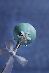 cake pops New Year with a satin ribbon on a blue background