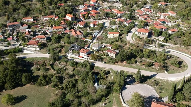 Aerial panoramic view of the picturesque village Mesovouni Located near Aristi village in Epirus, Greece. Scenic aerial view of traditional Greek villages in Autumn. Epirus, Greece, Europe.