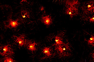 Close up of colorful lights on a Christmas tree. Photo taken at night. Lamps woven into the tree branches