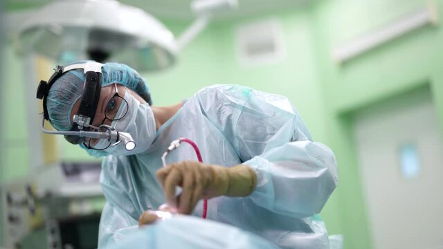 modern method of endoscopic removal of brain cancer tumor, woman doctor is operating