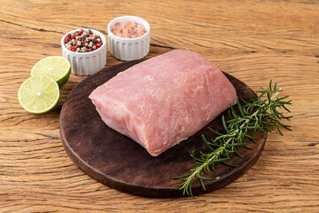 Raw pork loin meat over wooden board with seasonings - obrazy, fototapety, plakaty