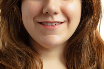 Close-up of open smiling female mouth without lips makeup. Cosmetology, medicine, dental health. Detailed.