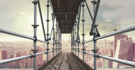 Construction scaffolding over a cityscape against clouds in the blue sky