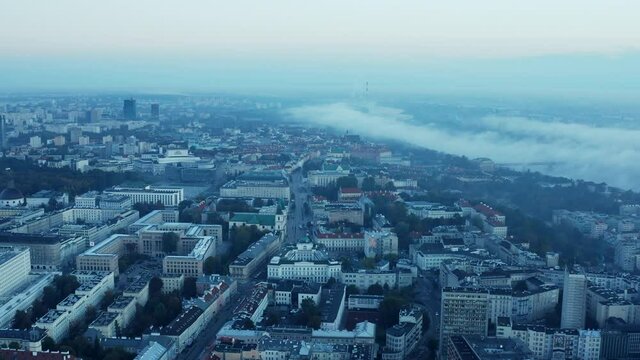 Morning aerial panoramic shot of buildings in town. Fog rolling in around Vistula riverbed. Warsaw, Poland