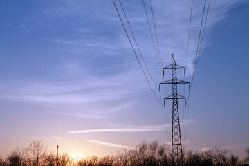 the pole of power lines at sunset