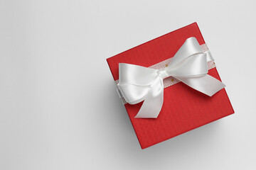 Gift box with bow on white background, top view