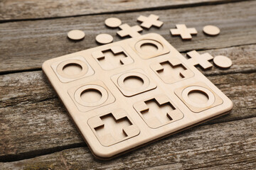 Tic tac toe set on wooden table, closeup