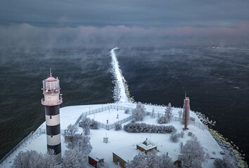 Breakwater leading into Baltic sea at winter. Sea covered in fog and ice blocks. Beautiful...