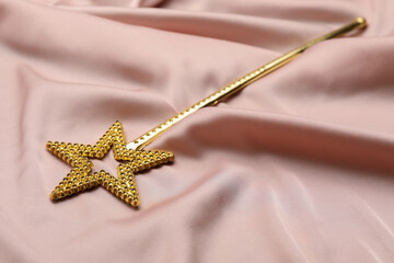 Beautiful golden magic wand on pink fabric