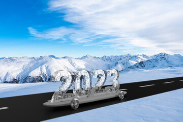 Ice glass 2023 new year car on skateboard and road in mountains winter background.