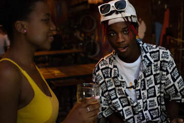 Young afro guy looks at the camera with a provocative attitude.