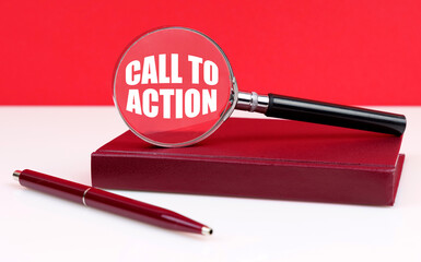 On a white and red background, a notebook, a pen and a magnifying glass, inside which the inscription - CALL TO ACTION