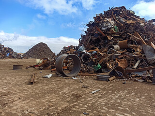 old rims and scrap metal at the port for shipment to the ship for processing. Recycling of...