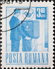 Romania - circa 1971: A post stamp printed in Romania showing a postman collecting the mail from...