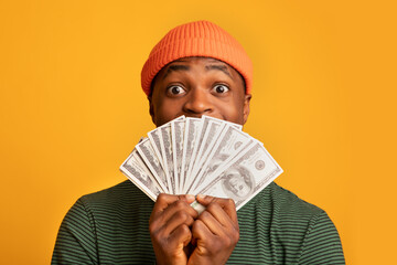Funny Black Guy Holding Dollar Cash Fan And Looking At Camera
