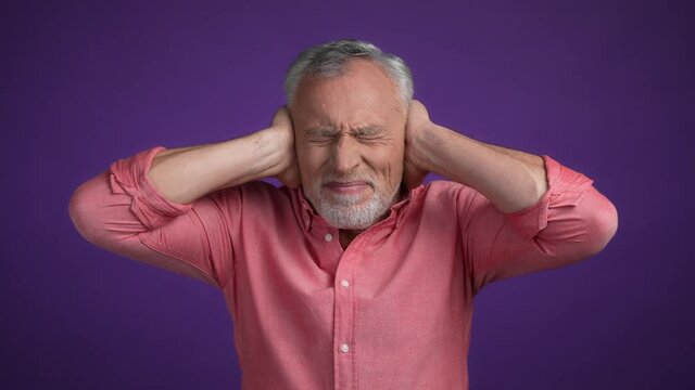 Displeased gentleman hide ears conflict hear isolated vivid color background
